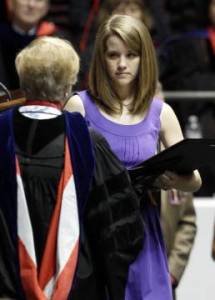 Michelle Downs Whatley accepts the diploma for her sister Danielle Downs who died in the April 27 tornado. (AP photo by Butch Dill)